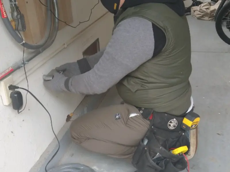 Electrician performing outlet wiring in a Meadow Vista garage